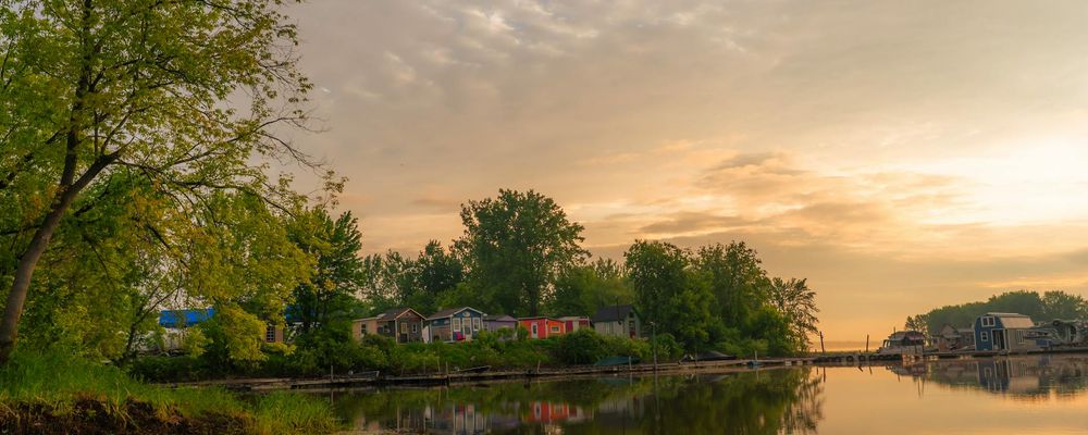 Panoramic view of a sunrise reflecting on calm water symbolizing clarity.